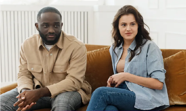 A man and woman sitting on top of a couch.